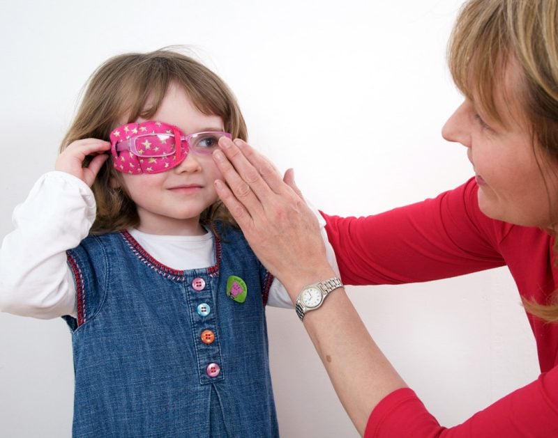 Orthoptist Hazel Kay fitting an MHRA compliant Kay Fun Patch on a young girl in a clinic